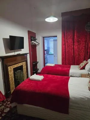a hotel room with two beds and a fireplace at The Residence - NO 57 in Edinburgh