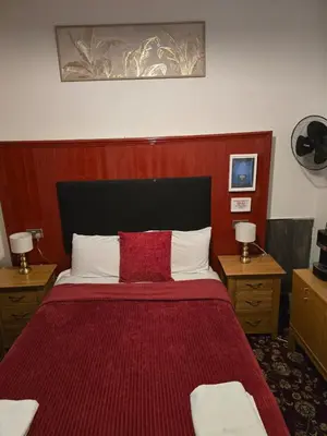a bedroom with a large bed with a red blanket at The Residence - NO 57 in Edinburgh