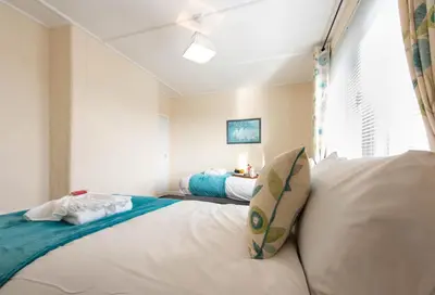 a bedroom with two beds and a window at PREMIER - Garfield House in Bellshill