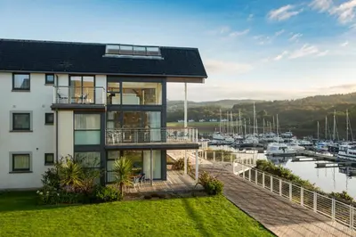 a house with a marina with boats at Portavadie Loch Fyne Scotland in Portavadie