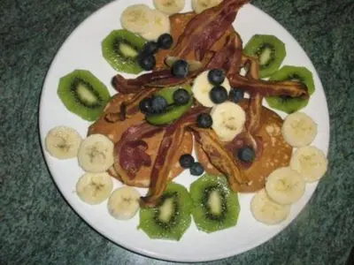 a plate of food with pancakes and fruit on it at Ashcroft Farmhouse in East Calder