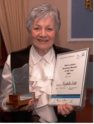 an older woman holding up a piece of paper at Ashcroft Farmhouse in East Calder