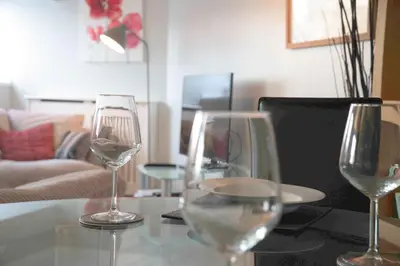 three wine glasses sitting on a table in a living room at The Stables - Fabulous stylish flat in Merchant City & Free Secure Parking in Glasgow