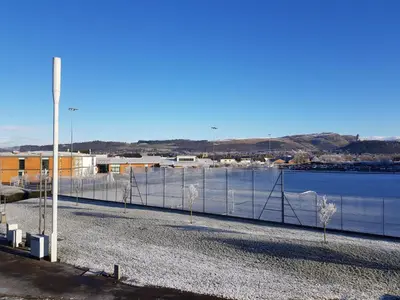 a fence in front of a body of water at 3 Royal View Apartments in Stirling