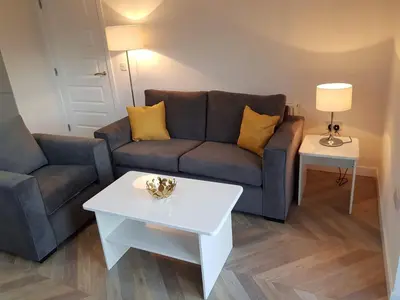 a living room with a couch and a table at 3 Royal View Apartments in Stirling