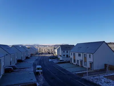 a street with houses and a car on the road at 3 Royal View Apartments in Stirling