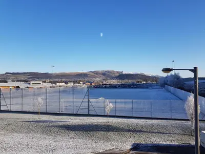 a fence next to a body of water at 5 Royal View Apartments in Stirling