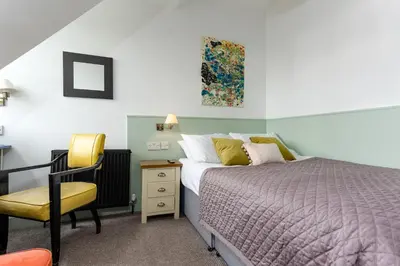 a bedroom with a bed and a chair and a desk at New Town Guest House (Adults Only) in Edinburgh