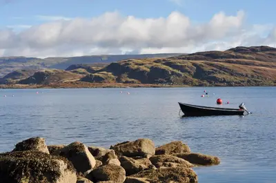 a boat in the middle of a large body of water at Kames Hotel in Tighnabruaich