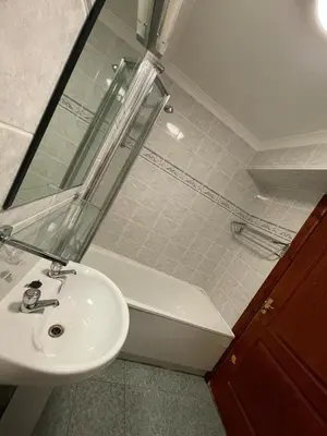 a bathroom with a sink and a bath tub at Lochway Hotel in Dumbarton