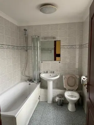 a bathroom with a tub and a sink and a toilet at Lochway Hotel in Dumbarton