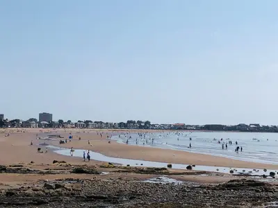 a group of people on a beach in the water at South Beach Apartment in Ardrossan