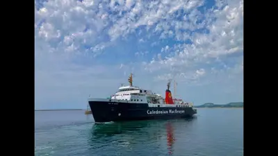 a large ship in the water under a cloudy sky at South Beach Apartment in Ardrossan