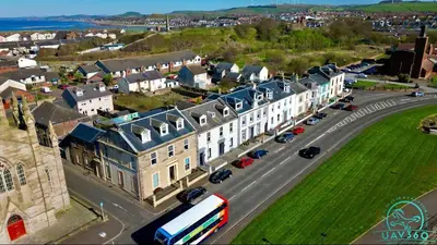 an aerial view of a town with a bus on a street at South Beach Apartment in Ardrossan