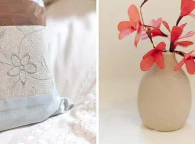 a vase with pink flowers in it next to a towel at Edinburgh Church Apartments in Edinburgh