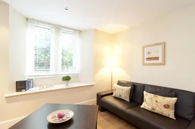 a living room with a couch and a table at Edinburgh Church Apartments in Edinburgh