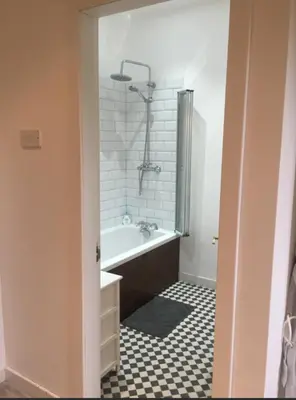a bathroom with a bath tub and a shower at The Coach House in Skelmorlie