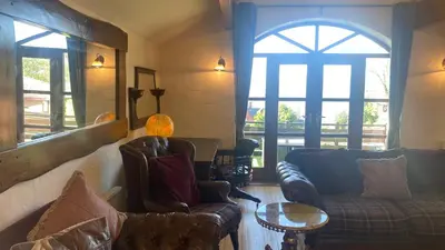 a living room with two couches and a window at The Coach House in Skelmorlie