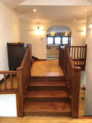 a wooden staircase in a room with a kitchen at The Coach House in Skelmorlie