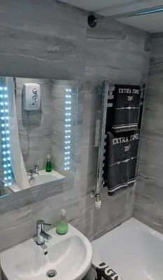 a bathroom with a sink and a mirror at Falcon Crest Guest House in Edinburgh