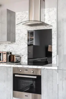 a kitchen with a stainless steel oven and a microwave at Spacious newly refurbished central apt in Edinburgh