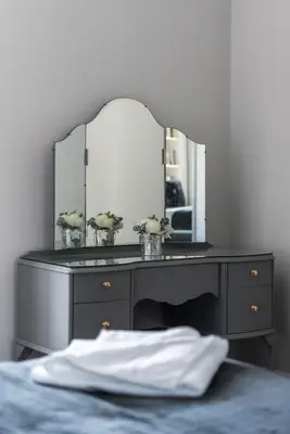 a dressing table with a mirror and a bed at Spacious newly refurbished central apt in Edinburgh