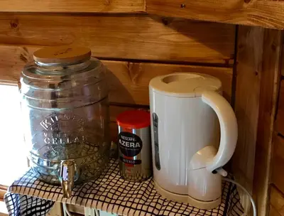 a shelf with a coffee maker and a jar on it at The Nest Glamping Pod in Dalmally