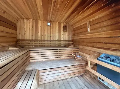 a wooden sauna with a wooden floor and wooden walls at Bonnie Banks Cottage in Balloch