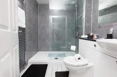 a bathroom with a shower and a toilet and a sink at Super Prime Park View Duloch by TBA in Dunfermline