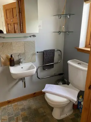 a bathroom with a toilet and a sink at Portbahn, Bruichladdich in Bruichladdich