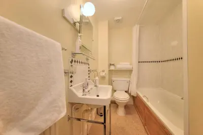 a bathroom with a sink and a toilet and a shower at Kilchrenan House in Oban