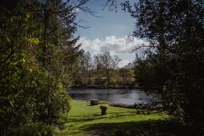 a view of a river through the trees at Thackray House in Callander