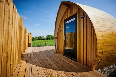 a wooden building with a door on a wooden deck at Luxury Hideaways in Keilour
