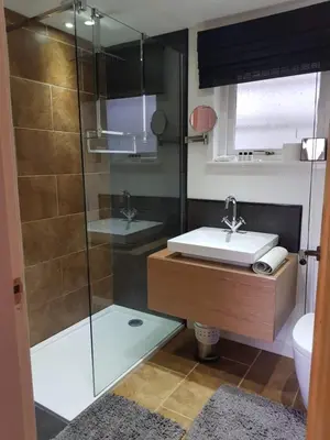 a bathroom with a glass shower and a sink at Achray House Restaurant with Rooms in Saint Fillans