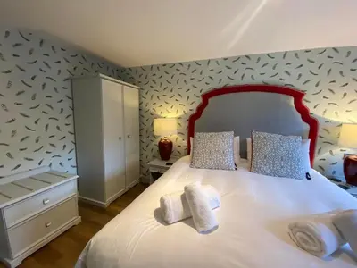 a bedroom with a bed with two towels on it at Achray House Restaurant with Rooms in Saint Fillans