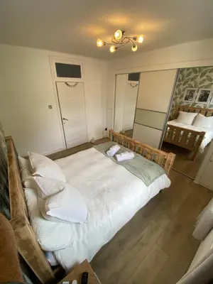 a bedroom with a large bed with two towels on it at Modern Quiet City Center Airport 2 Bedroom Apartment in Edinburgh