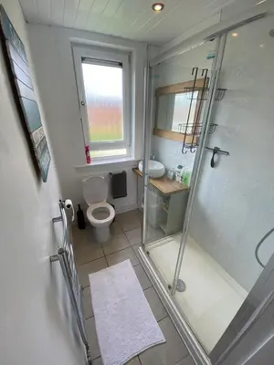 a bathroom with a shower and a toilet and a sink at Modern Quiet City Center Airport 2 Bedroom Apartment in Edinburgh