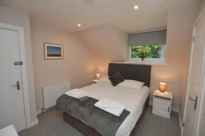 a bedroom with a bed with two towels on it at Fairhaven, Oban Town Centre in Oban