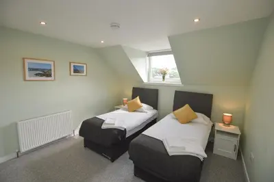 a room with two beds and a window at Fairhaven, Oban Town Centre in Oban