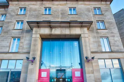 a building with a large glass door in front of it at Leonardo Hotel Edinburgh Haymarket in Edinburgh