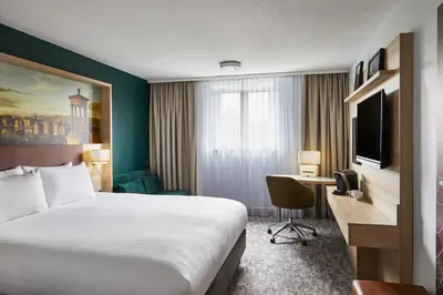 a hotel room with a bed and a desk at Leonardo Hotel Edinburgh Haymarket in Edinburgh