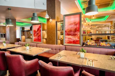 a dining room with tables and chairs and a restaurant at Leonardo Hotel Edinburgh Haymarket in Edinburgh