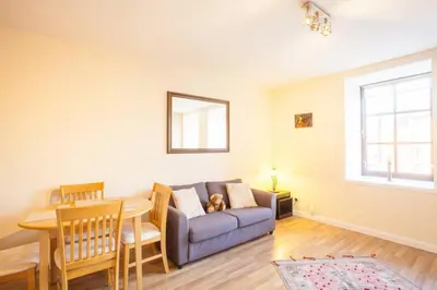 a living room with a couch and a table at Stylish Merchant City Flat in Glasgow