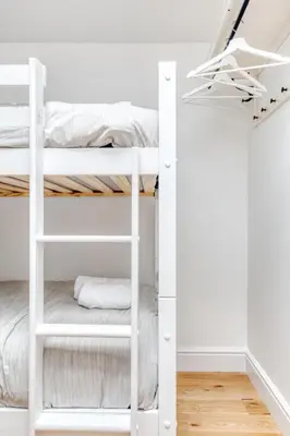 a white bunk bed in a white room at Central Bright 3 Bed Flat with Pool & Parking in Edinburgh