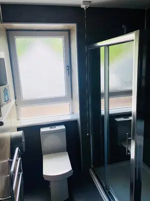 a bathroom with a toilet and a window at Islay Frigate Hotel in Tarbert