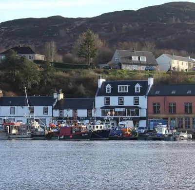 a group of boats are docked in a harbor at Islay Frigate Hotel in Tarbert