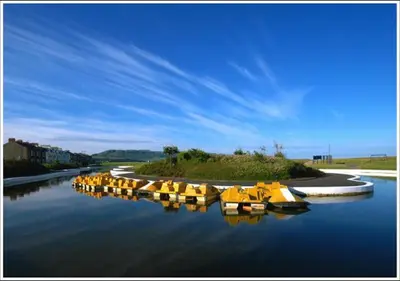 a row of yellow boats sitting in the water at Fisher Holiday Cottage Ayrshire in Girvan