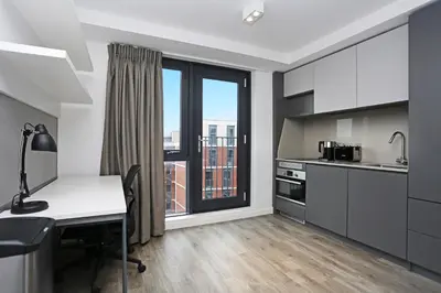 a kitchen with a table and a desk with a window at JOIVY at VITA Fountainbridge - Adults only - Breakfast buffet in Edinburgh