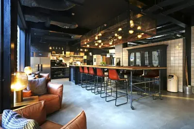 a bar with chairs and a table in a room at JOIVY at VITA Fountainbridge - Adults only - Breakfast buffet in Edinburgh