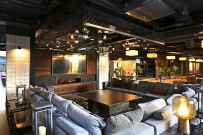 a living room with couches and a table and a tv at JOIVY at VITA Fountainbridge - Adults only - Breakfast buffet in Edinburgh